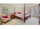 Serene bedroom featuring a four-poster bed and natural light from the windows at 2007 Woodside Park Dr, Woodstock, GA 30188