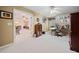 Bright home office with neutral walls, white carpet, built-in shelves, desk and access to another room at 2007 Woodside Park Dr, Woodstock, GA 30188