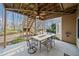 Covered patio with outdoor dining area and stairs leading to a two-level deck above at 2007 Woodside Park Dr, Woodstock, GA 30188