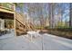 Backyard patio with outdoor seating, steps to elevated deck, and lush landscaping at 2007 Woodside Park Dr, Woodstock, GA 30188