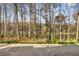 Scenic backyard with a view of a tranquil lake surrounded by lush trees and greenery at 4458 Paces Battle Nw, Atlanta, GA 30327