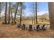 Outdoor seating area featuring multiple chairs with scenic view of a river and trees in backyard at 4458 Paces Battle Nw, Atlanta, GA 30327