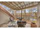 Stylish balcony features a metal roof, tiled floor, comfortable seating, and views of nature at 4458 Paces Battle Nw, Atlanta, GA 30327