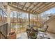 Inviting outdoor balcony with a metal roof, comfy chairs, and beautiful views of the trees and lake at 4458 Paces Battle Nw, Atlanta, GA 30327