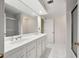 Bathroom with double sink vanity, white cabinets and tile, plus glass shower enclosure at 4458 Paces Battle Nw, Atlanta, GA 30327