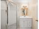 Bathroom featuring a glass shower, decorative mirror, and white vanity at 4458 Paces Battle Nw, Atlanta, GA 30327