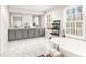 Bright bathroom with double vanity, freestanding tub, marble floor and large windows at 4458 Paces Battle Nw, Atlanta, GA 30327