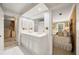 Bathroom featuring a double sink vanity with white cabinets and view into an adjacent bedroom at 4458 Paces Battle Nw, Atlanta, GA 30327