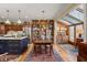 Bright dining area with wooden cabinets, stainless appliances, large table, and views of sunroom at 4458 Paces Battle Nw, Atlanta, GA 30327