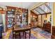 Bright dining area with wooden cabinets, stainless appliances, large table, and views of sunroom at 4458 Paces Battle Nw, Atlanta, GA 30327