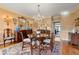 Spacious dining room with hardwood floors, chandelier, and a view into the kitchen at 4458 Paces Battle Nw, Atlanta, GA 30327