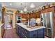 Well-equipped kitchen features wood cabinets, stainless steel appliances, center island, and view to dining area at 4458 Paces Battle Nw, Atlanta, GA 30327