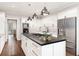Modern kitchen featuring white cabinetry, stainless steel appliances, and a large center island with cooktop at 4458 Paces Battle Nw, Atlanta, GA 30327