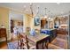 Kitchen area with a dining table set featuring wood cabinetry, stainless appliances, and view to dining area at 4458 Paces Battle Nw, Atlanta, GA 30327