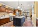 Spacious kitchen features wood cabinets, center island with cooktop, stainless appliances, and adjacent dining area at 4458 Paces Battle Nw, Atlanta, GA 30327