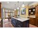 Open kitchen with contrasting island, wood cabinetry, stainless appliances, and adjacent dining area with natural light at 4458 Paces Battle Nw, Atlanta, GA 30327