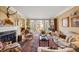Elegant living room featuring a fireplace, large windows, hardwood floors, and classic furnishings at 4458 Paces Battle Nw, Atlanta, GA 30327
