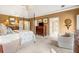 Spacious main bedroom featuring a four poster bed, sitting area, and ensuite bath at 4458 Paces Battle Nw, Atlanta, GA 30327