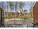 Outdoor patio overlooking a peaceful, wooded area and lake with wrought iron furniture at 4458 Paces Battle Nw, Atlanta, GA 30327