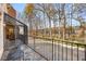 Outdoor patio with lake views and wrought iron furniture, connected to a sunroom at 4458 Paces Battle Nw, Atlanta, GA 30327