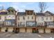 Rear view of townhomes with private garages and upper level sunrooms at 4458 Paces Battle Nw, Atlanta, GA 30327