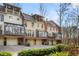 Rear exterior of townhomes with private garages and sunroom additions at 4458 Paces Battle Nw, Atlanta, GA 30327