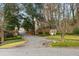 Exclusive gated community entrance featuring pristine landscaping and a security booth at 4458 Paces Battle Nw, Atlanta, GA 30327