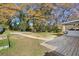 Grassy backyard with a deck, mature trees and surrounding white fence at 1522 Waltham Se Pl, Atlanta, GA 30316