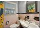 Charming bathroom featuring pink tile, a white vanity, and a vintage-inspired aesthetic at 1522 Waltham Se Pl, Atlanta, GA 30316