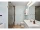 Well-lit bathroom featuring a glass shower, white sink, and vanity at 1522 Waltham Se Pl, Atlanta, GA 30316