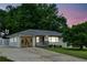 Charming single-story home with white painted brick and a well-maintained front yard at twilight at 1522 Waltham Se Pl, Atlanta, GA 30316