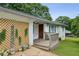 Close up of single-story home with small front porch and decorative wooden trellis on the side at 1522 Waltham Se Pl, Atlanta, GA 30316