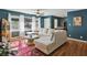 Spacious living room featuring hardwood floors and a large sectional sofa at 1522 Waltham Se Pl, Atlanta, GA 30316