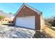 Attached brick garage with a white door at 985 James Ridge Dr, Lawrenceville, GA 30045