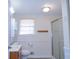 Clean bathroom with shower, double vanity and window at 10155 Twin Oaks Sw Dr, Covington, GA 30014