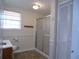 Bathroom with shower stall, tile floor and window at 10155 Twin Oaks Sw Dr, Covington, GA 30014