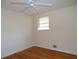 Simple bedroom with hardwood floors and ceiling fan at 10155 Twin Oaks Sw Dr, Covington, GA 30014