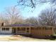 Brick ranch house with green shutters, and a spacious front yard at 10155 Twin Oaks Sw Dr, Covington, GA 30014