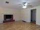 Living room with hardwood floors, brick fireplace and access to hallway at 10155 Twin Oaks Sw Dr, Covington, GA 30014