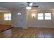 Living room with hardwood floors, ceiling fan and entryway at 10155 Twin Oaks Sw Dr, Covington, GA 30014