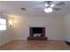 Living room with hardwood floors, brick fireplace and ceiling fan at 10155 Twin Oaks Sw Dr, Covington, GA 30014