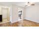 Living area featuring hardwood floors leading into the kitchen at 408 River Run Dr, Atlanta, GA 30350