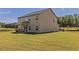 The backyard features a spacious lawn and a covered patio, ideal for outdoor activities and relaxation at 257 Orwell Dr, Social Circle, GA 30025
