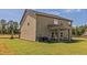 This spacious backyard features a large lawn and a covered patio, perfect for outdoor gatherings and activities at 257 Orwell Dr, Social Circle, GA 30025