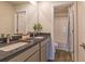 The bathroom features double sinks with a granite countertop and a large mirror, adding elegance and functionality at 257 Orwell Dr, Social Circle, GA 30025