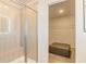 Bright and stylish bathroom featuring glass shower, bench and large walk in closet space at 257 Orwell Dr, Social Circle, GA 30025