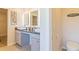 Modern bathroom with dual sinks, granite countertops, illuminated mirrors, and stylish fixtures, offering a luxurious feel at 257 Orwell Dr, Social Circle, GA 30025