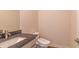 This bathroom features a granite sink, modern toilet, and fixtures, providing a luxurious experience at 257 Orwell Dr, Social Circle, GA 30025