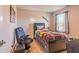 This cool bedroom features a bed, gaming chair, and natural light, making it a perfect space for relaxation and recreation at 257 Orwell Dr, Social Circle, GA 30025