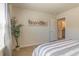 This modern bedroom boasts neutral walls with sleek decor, carpet, and access to an ensuite bathroom at 257 Orwell Dr, Social Circle, GA 30025